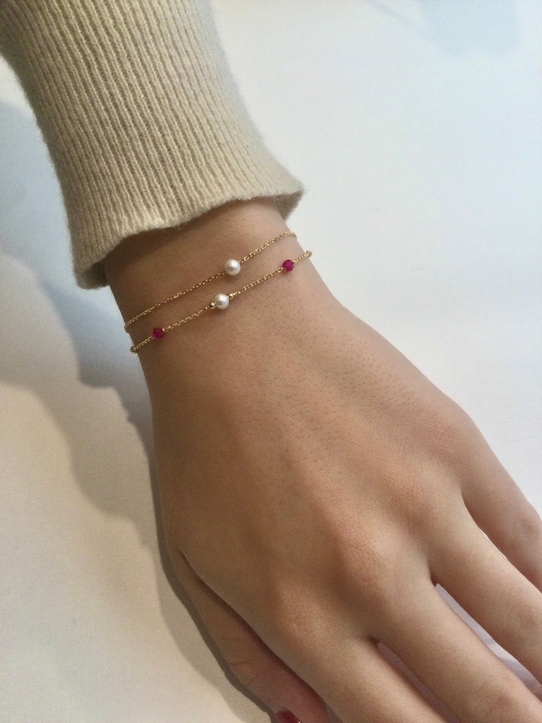 Gold bracelet with ruby stones and pearl